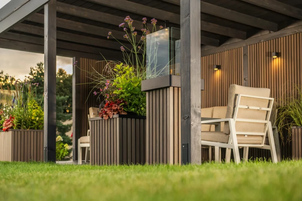 Espace terrasse modulaire en bois Solvia avec assises extérieures, bacs végétalisés et ambiance naturelle sous structure couverte